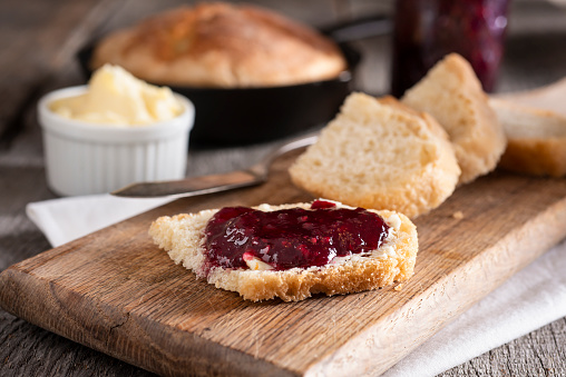 Homemade Cast Iron Skillet Bread with Butter and Raspberry Jam