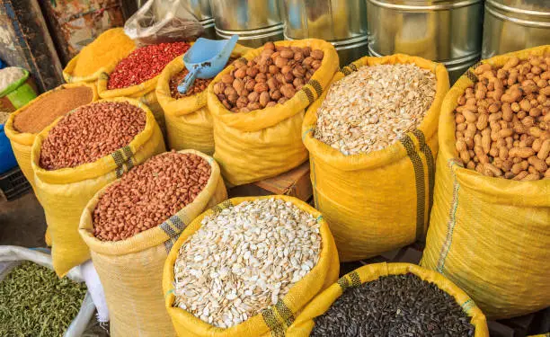 Nuts, seeds and legumes in canvas bags at the traditional souk market in the medina or old town of Fes, Morocco