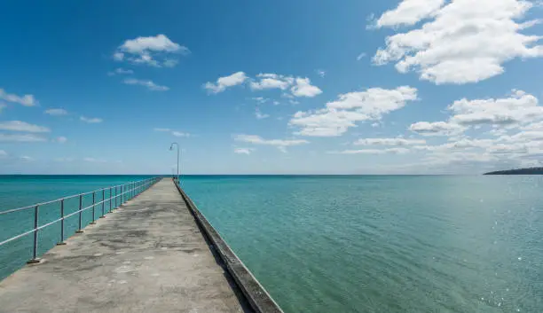 Dromana pier on a sunny day, stretching out into a blue calm bay