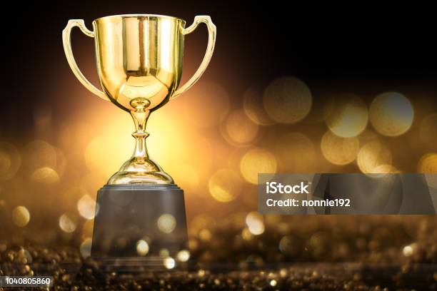 Trophy Over Wooden Table And Dark Background Stock Photo - Download Image Now - Trophy - Award, Award, Winning