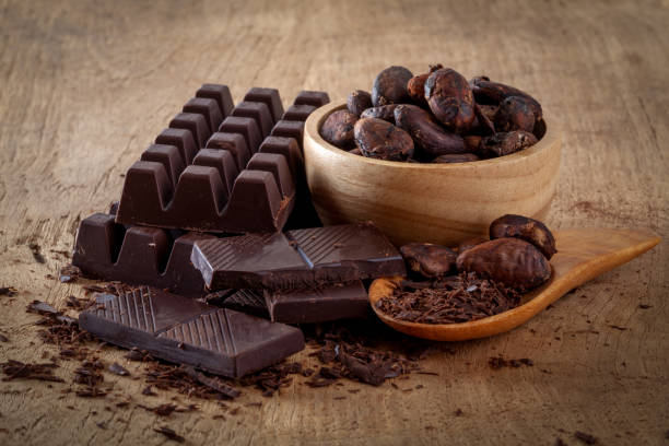 istock Raw cocoa beans, chocolate on wood background 1040806824