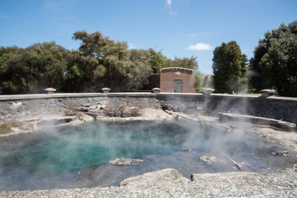 Rotorua, North Island, New Zealand - December 16,2016: Turquoise coloured thermal pool with old bathhouse building in Rotorua, New Zealand