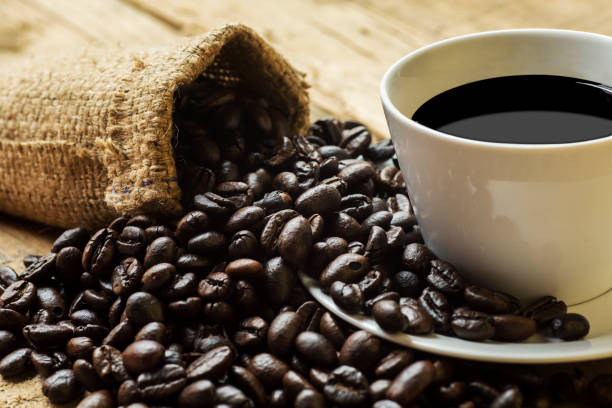 istock Coffee beans and burlap bag with black coffee 1040814086