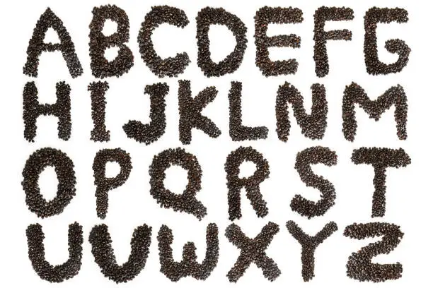 Image of roasted coffee beans shaped alphabet, isolated on white background