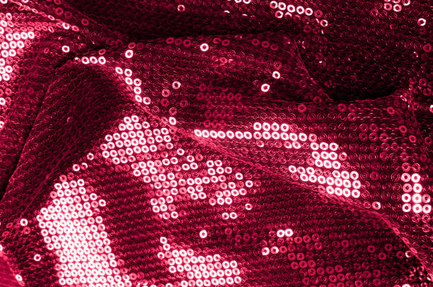 istock Background texture, pattern. Cloth red maroon with paillettes. Look at these Neon Pink Paillette Sequins. Round neon pink paillette sequins overlap with an iridescent sheen across a sheer purple mesh 1040820788