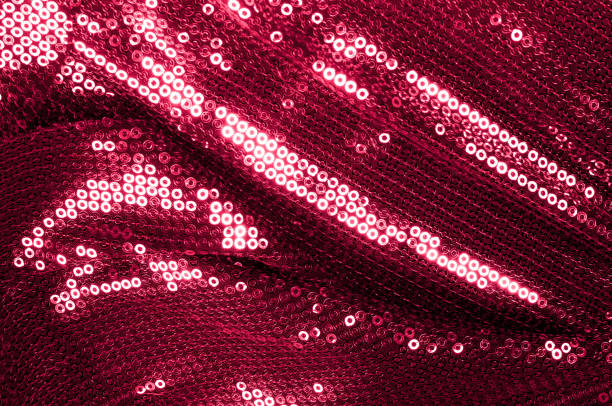 istock Background texture, pattern. Cloth red maroon with paillettes. Look at these Neon Pink Paillette Sequins. Round neon pink paillette sequins overlap with an iridescent sheen across a sheer purple mesh 1040821118