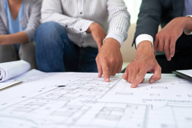 istock Broker and clients discussing blueprint 1040824696