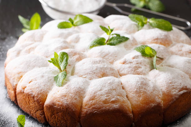 istock Austrian buchteln (sweet yeast rolls) decorated with mint and powdered sugar close-up. horizontal 1040841972