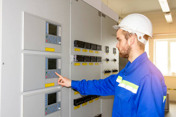 istock Electrician Engineer on control board. Worker controls industrial processes. Automation point for control machines. High tech in energy 1040842132