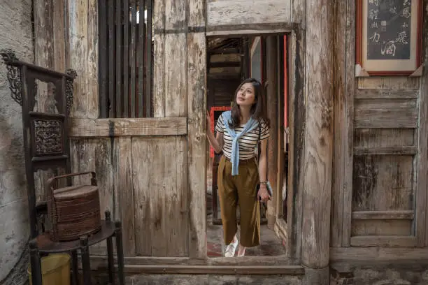 woman visiting the old chinese house. with old furniture and decoration.