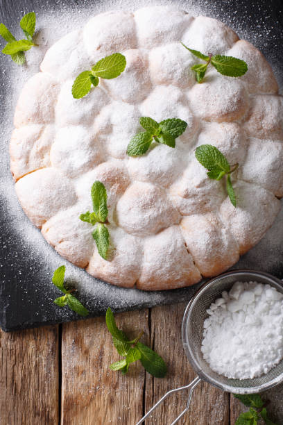 istock sweet Austrian rolls buchteln with powdered sugar close-up. Vertical top view 1040844256