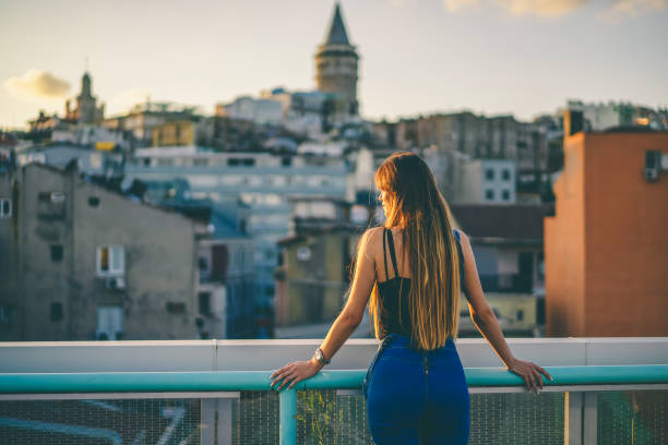 istock girl watching the galata tower 1040845424
