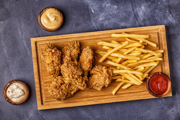 istock Fried chicken wings with french fries 1040846840