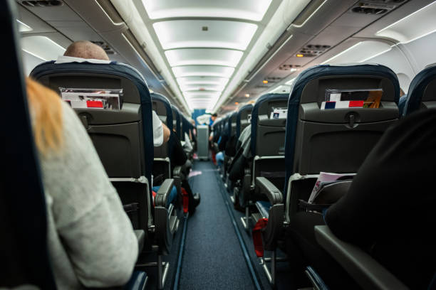 istock Airplane cabin with passengers on the seats. 1040850770