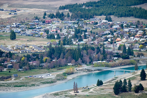 Houses of New Zealand. This shot is taken from the top of a hill. You can see road connections, small houses and infrastructure. Every tiny details make up the town.