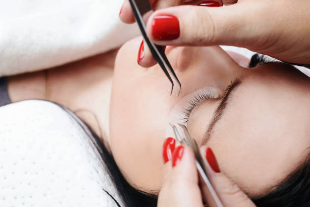istock Eyelash Extension Procedure. Woman Eye with Long Eyelashes. Lashes, close up, macro, selective focus 1040859890