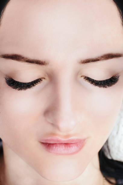 istock Eyelash Extension Procedure. Woman Eye with Long Eyelashes. Lashes, close up, macro, selective focus 1040860034