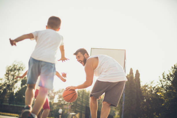 istock Happy father playing outside with his children. 1040872542