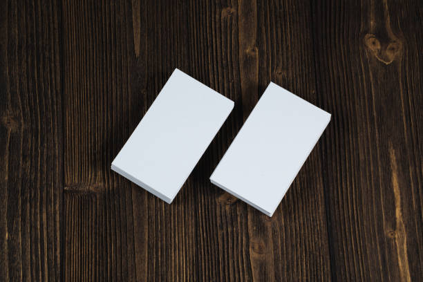 istock Blank business cards on wooden working table with copy space for add text ID. and logo, business company concept. 1040872974