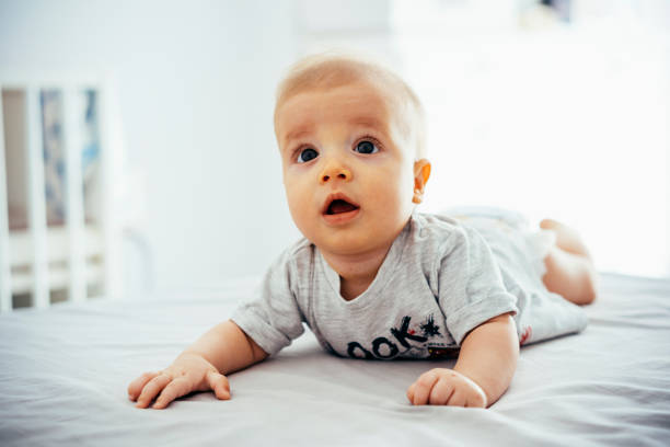istock Adorable baby boy having tummy time on bed 1040878048
