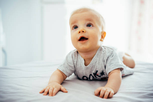 istock Adorable baby boy having tummy time on bed 1040878108