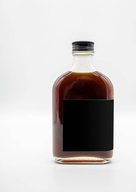 Cold Brew Coffee in glass bottle with black cap isolated on white background