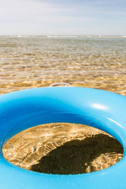 istock Blue rubber ring floating on the clear shallow sea at Pedn Vounder Beach, Cornwall 1040882636