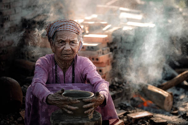 istock Old woman Vietnam doing traditional pottery. 1040882942