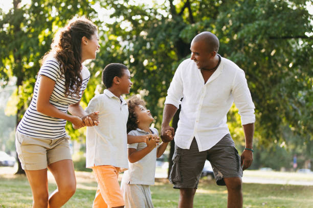 istock Happy couple spending time with their sons in the park 1040886404