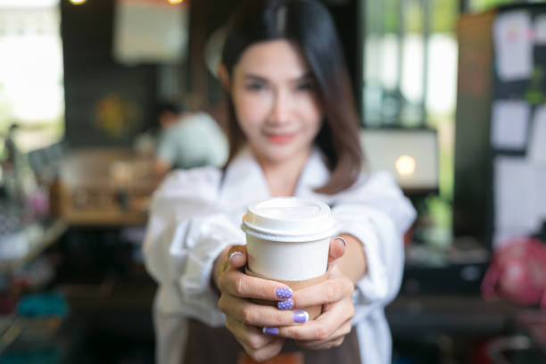istock Woman bartender serving customer at coffee shop. 1040890344