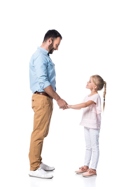 istock smiling father and daughter holding hands and looking at each other isolated on white 1040896156
