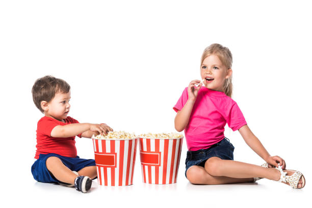 istock kids with popcorn and 3d glasses isolated on white 1040903090