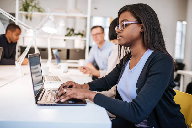 istock Successful and determined African-American journlist working in shared office 1040905438
