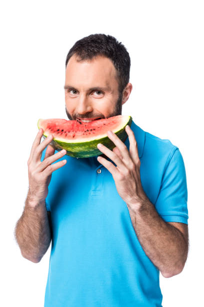 istock man in blue polo eating watermelon isolated on white 1040905444