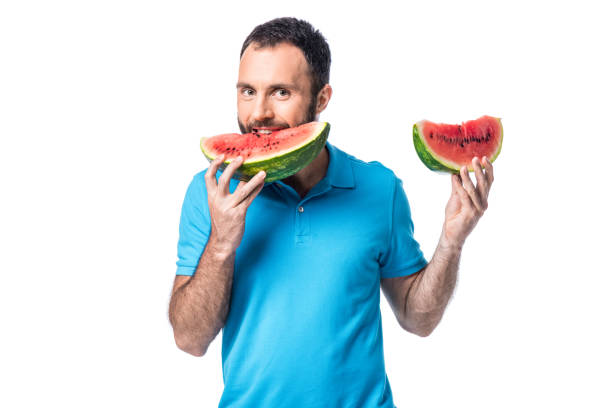 istock man eating watermelon and looking at camera isolated on white 1040905488