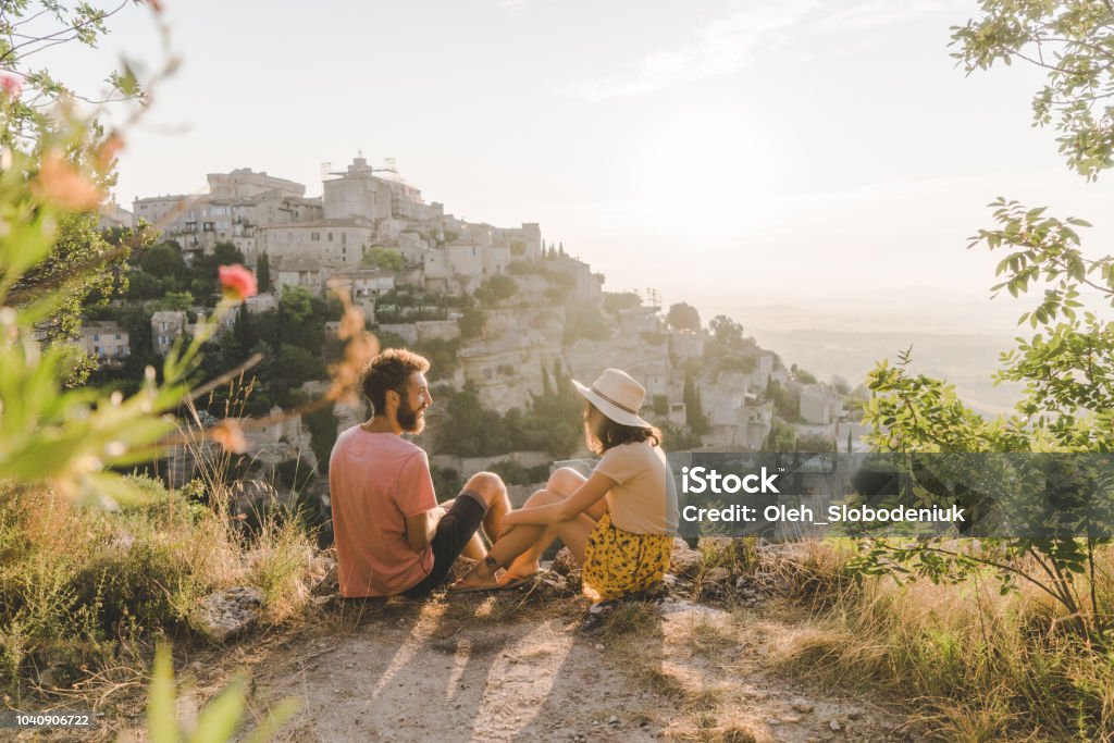 Woman and man looking at scenic view  of Gordes village in Provence Young Caucasian woman and man looking at scenic view  of Gordes village in Provence Vacations Stock Photo