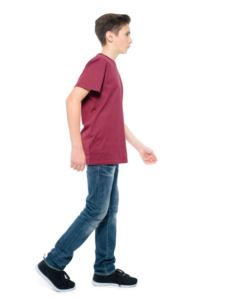 istock teen boy walking - posing at studio 1040916118