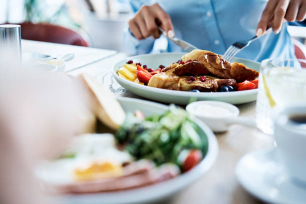 Close up of people having breakfast in restaurant