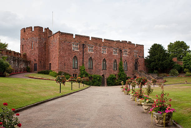 Taunton Somerset England.  The exterior walls of the castle built circa 1216 from former Augustine priory. Gardens in the former moat. Rounded two story walls. Blue sky no people