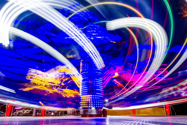 長い露出写真、遊園地でカラフルな糸車からライトの抽象的なトレイル - ferris wheel wheel blurred motion amusement park ストックフォトと画像