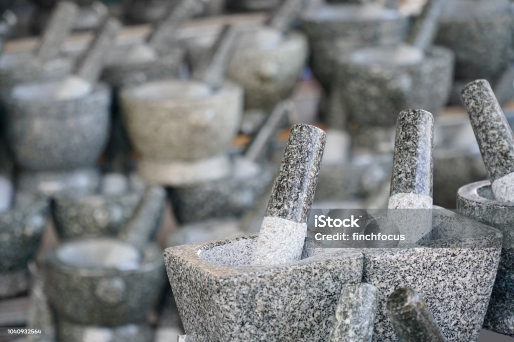 Stone mortar is kitchenware for preparation for cooking food. Stone mortar in the mortar store. Stone mortar is kitchenware for preparation for cooking food. Black Color Stock Photo