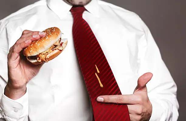 angry businessman with shirt, tie and burger. mustard spots on tie. Need more pictures like this: