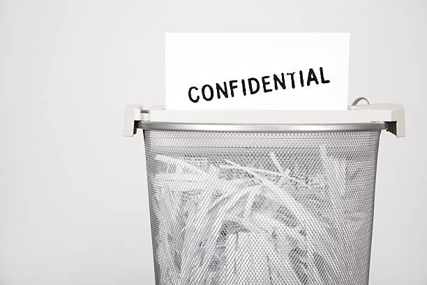 shredder shredding a confidential document in a wastepaper bin wastepaper basket photos stock pictures, royalty-free photos & images