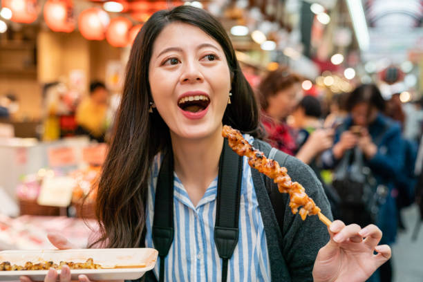 istock asian tourist feeling happy with her food. 1040936668