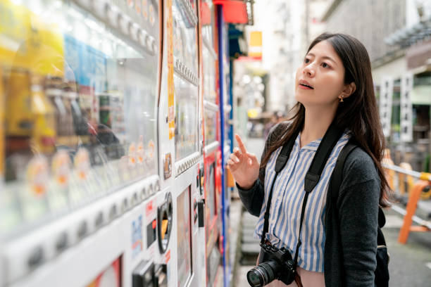 istock asian female choosing what to drink. 1040937170