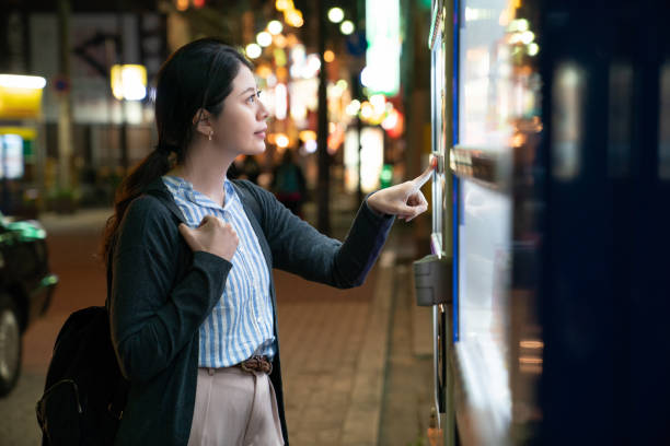 femme d’origine asiatique ce que vous cherchez à boire. - vending machine photos et images de collection