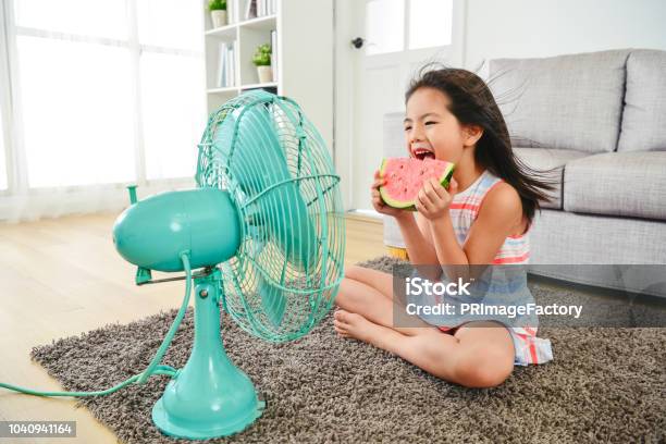 Child Eating Watermelon With Two Hands Stock Photo - Download Image Now - Heat - Temperature, Summer, Electric Fan