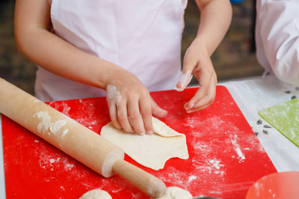 istock the child rolls out the dough for baking 1040941340