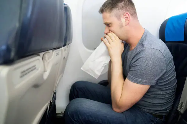 Airsickness. Man feels very bad on the plane.