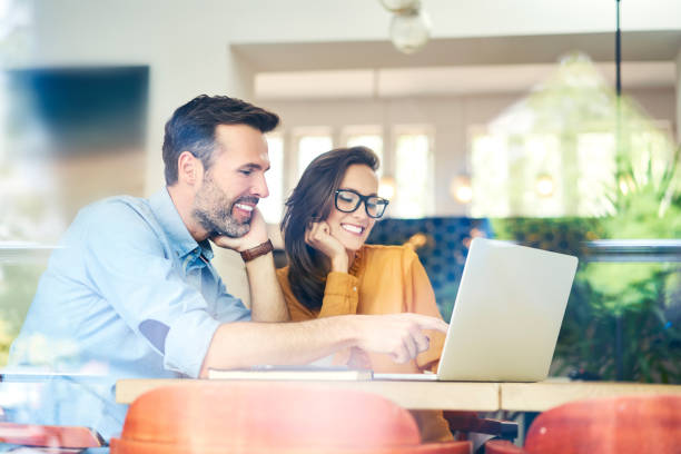 istock Two business partners looking at laptop while having meeting in cafe 1040949124